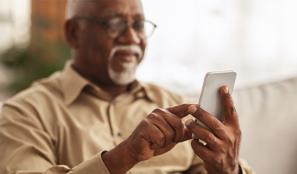 older black man using a phone